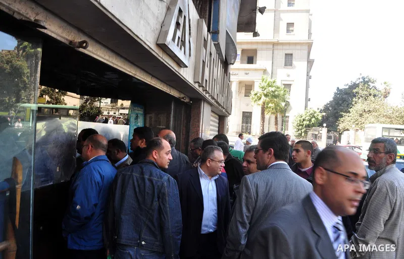 Egyptians gather in front of a shop for weapons in Cairo, Egypt, March 7, 2011. Photo by Ahmed Asad