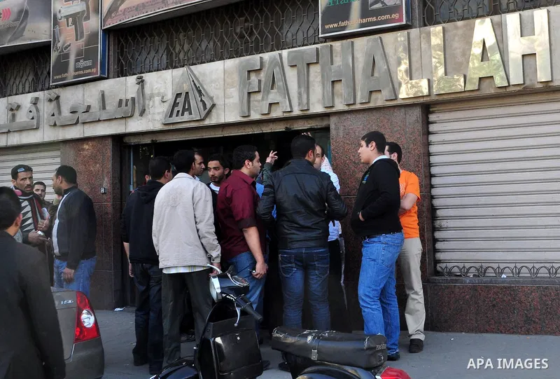 Egyptians gather in front of a shop for weapons in Cairo, Egypt, March 7, 2011. Photo by Ahmed Asad