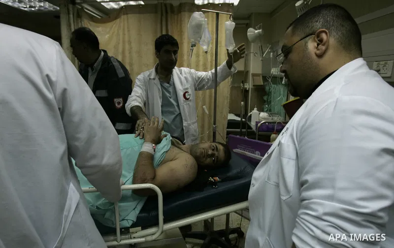 Palestinian doctors attend to a wounded youth at a hospital after being shot by a group of Jewish settlers in the village of his palace in the West Bank near Nablus March 7, 2011 , Jewish settlers and wounded 10 Palestin...
