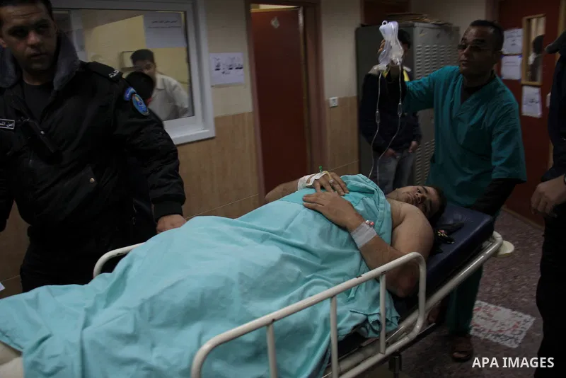 Palestinian doctors attend to a wounded youth at a hospital after being shot by a group of Jewish settlers in the village of his palace in the West Bank near Nablus March 7, 2011 , Jewish settlers and wounded 10 Palestin...