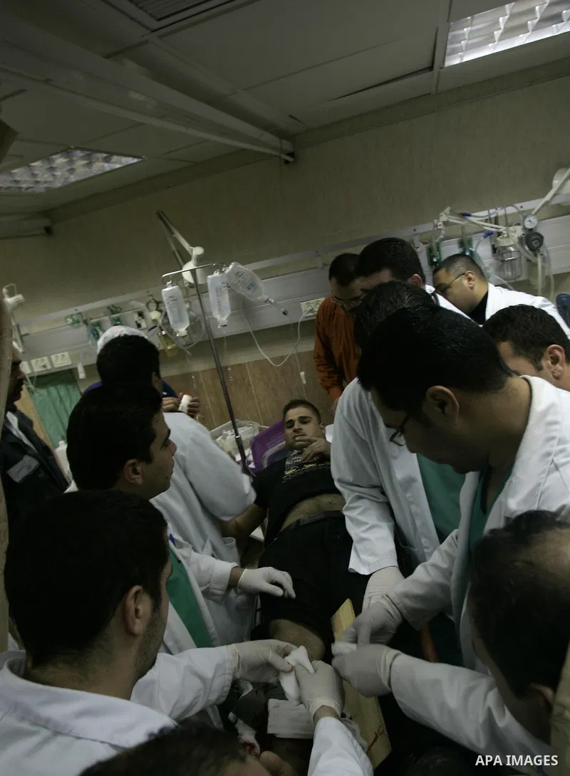 Palestinian doctors attend to a wounded youth at a hospital after being shot by a group of Jewish settlers in the village of his palace in the West Bank near Nablus March 7, 2011 , Jewish settlers and wounded 10 Palestin...