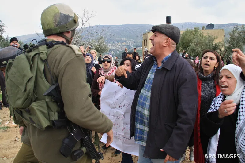 Palestinian women shout slogans during women's demonstration in the West Bank village of Burin, near Nablus, Tuesday ,March 8, 2011. The protest was organized by Palestinian women to mark the International Women's Day an...