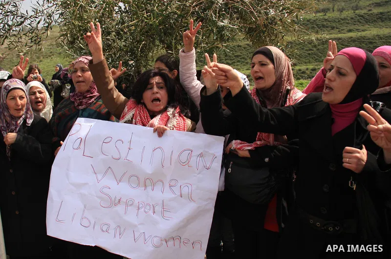 Palestinian women shout slogans during women's demonstration in the West Bank village of Burin, near Nablus, Tuesday ,March 8, 2011. The protest was organized by Palestinian women to mark the International Women's Day an...