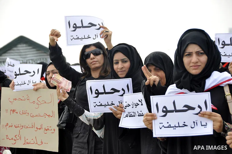 Bahraini anti-government women protesters wave flags and hold signs Tuesday, March 8, 2011, in Manama, Bahrain, to mark the International Woman Day. Photo by Ammar A.rasool