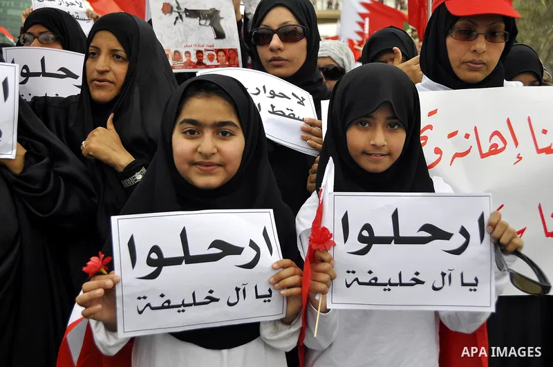 Bahraini anti-government women protesters wave flags and hold signs Tuesday, March 8, 2011, in Manama, Bahrain, to mark the International Woman Day. Photo by Ammar A.rasool