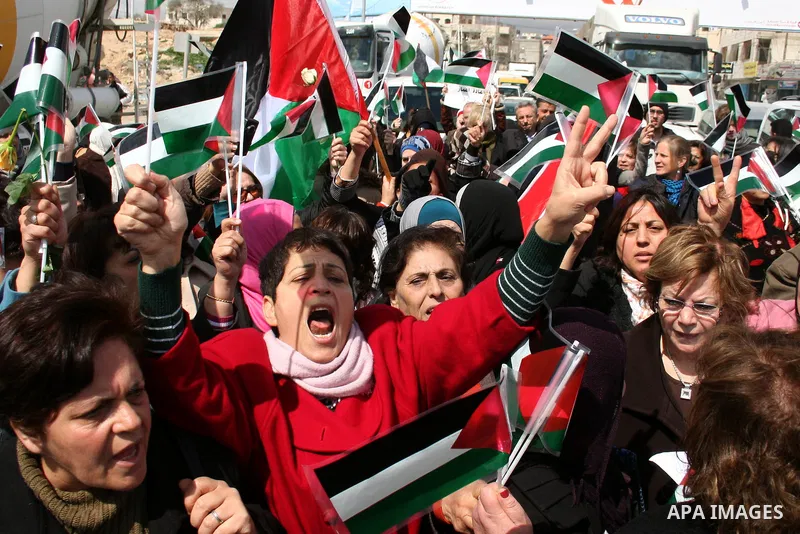 Palestinian women protest against the Israeli occupation of Palestinian territories on the occasion of women's day on March 8, 2011 at the Israeli-controlled Qalandia checkpoint, between Jerusalem and Ramallah. photo by:...