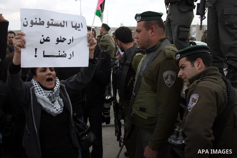Palestinian women protest against the Israeli occupation of Palestinian territories on the occasion of women's day on March 8, 2011 at the Israeli-controlled Qalandia checkpoint, between Jerusalem and Ramallah. photo by:...
