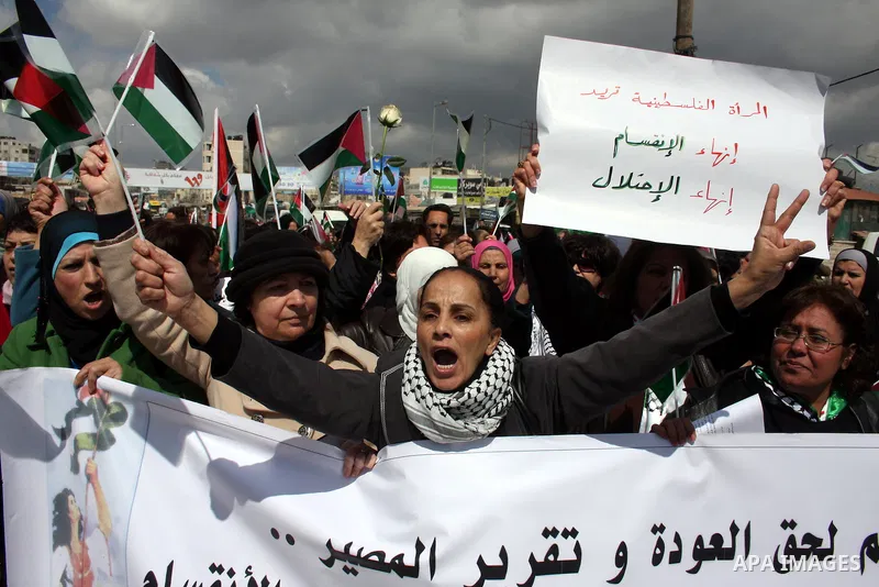 Palestinian women protest against the Israeli occupation of Palestinian territories on the occasion of women's day on March 8, 2011 at the Israeli-controlled Qalandia checkpoint, between Jerusalem and Ramallah. photo by:...