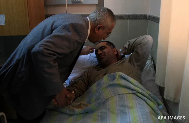 Palestinian Prime Minister Salam Fayyad visits the wounded Palestinians who injured during attack by Israeli settlers, at Rafidia hospital in the West Bank city of Nablus ,Tuesday, March 8, 2011. Jewish settlers opened f...