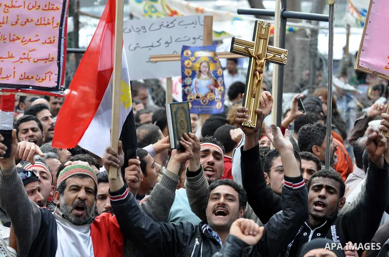 Egyptian Coptic Christians take part in a protest in front of the Information center building in Cairo, Egypt, 09 March 2011. The Coptic Christians were protesting over the burning of a church in Cairo suburbs on 04 Marc...