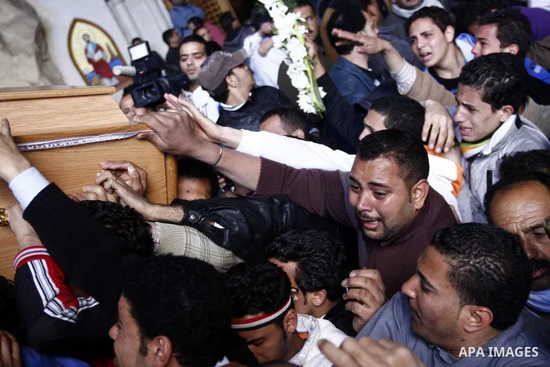 Egyptian Coptic Christians gather for a mass funeral procession at the Samaan el-Kharaz Church in Cairo on March 10, 2011 after at least 13 people were killed in sectarian clashes which erupted when 1,000 Christians gath...