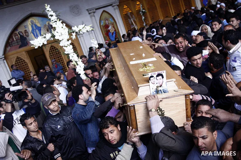Egyptian Coptic Christians gather for a mass funeral procession at the Samaan el-Kharaz Church in Cairo on March 10, 2011 after at least 13 people were killed in sectarian clashes which erupted when 1,000 Christians gath...