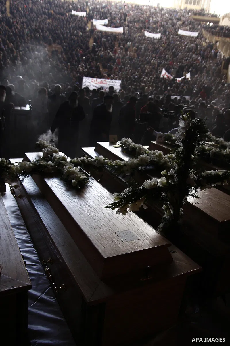 Egyptian Coptic Christians gather for a mass funeral procession at the Samaan el-Kharaz Church in Cairo on March 10, 2011 after at least 13 people were killed in sectarian clashes which erupted when 1,000 Christians gath...