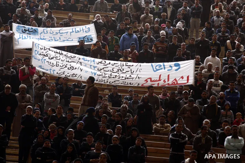 Egyptian Coptic Christians gather for a mass funeral procession at the Samaan el-Kharaz Church in Cairo on March 10, 2011 after at least 13 people were killed in sectarian clashes which erupted when 1,000 Christians gath...
