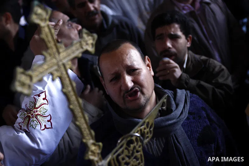 Egyptian Coptic Christians gather for a mass funeral procession at the Samaan el-Kharaz Church in Cairo on March 10, 2011 after at least 13 people were killed in sectarian clashes which erupted when 1,000 Christians gath...