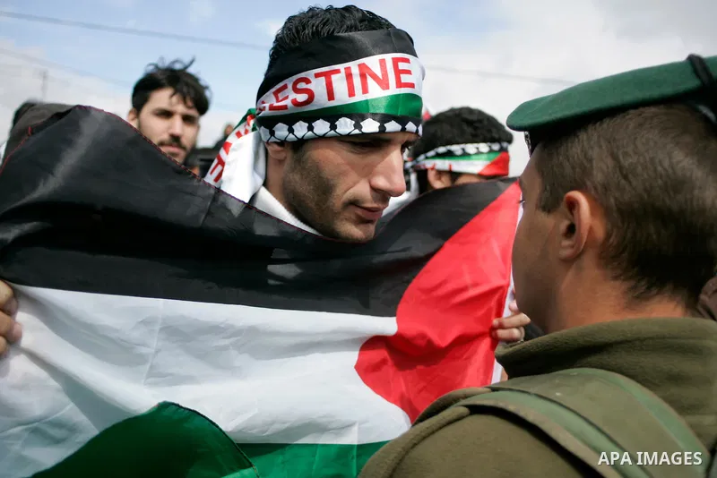 Protesters argue with Israeli soldiers during a demonstration against Israel's controversial separation barrier in the West Bank village of Maasarah, near the biblical town of Bethlehem on March 11, 2011.Israel says the...