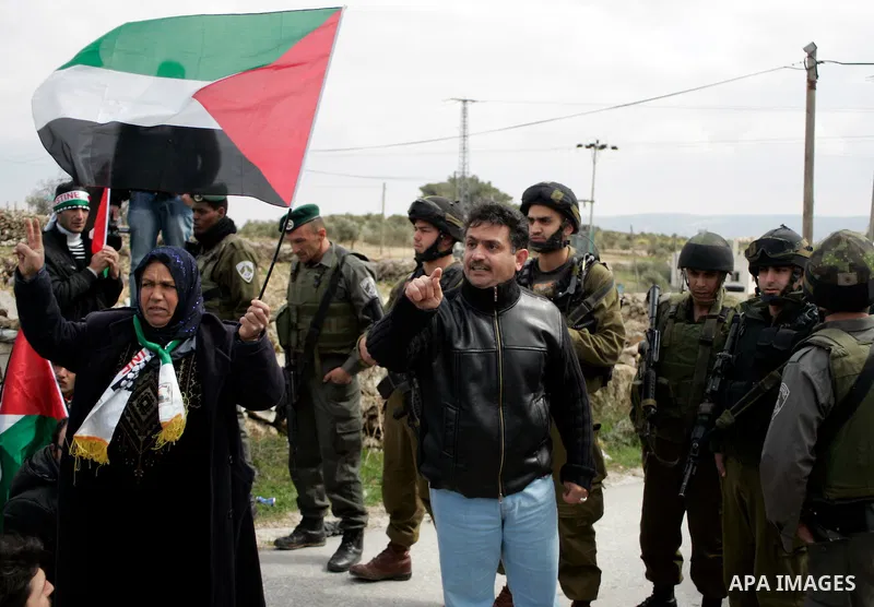 Protesters argue with Israeli soldiers during a demonstration against Israel's controversial separation barrier in the West Bank village of Maasarah, near the biblical town of Bethlehem on March 11, 2011.Israel says the...