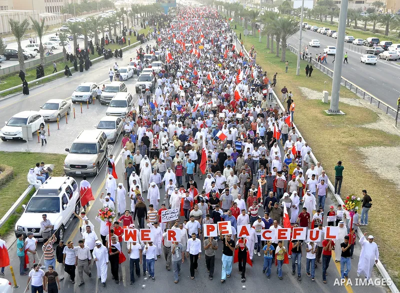 Thousands of Bahraini anti-government demonstrators chant slogans against the king on March 11, 2011 as they march toward the royal palace in Manama where a group of pro-regime loyalists waited with clubs, swords and met...