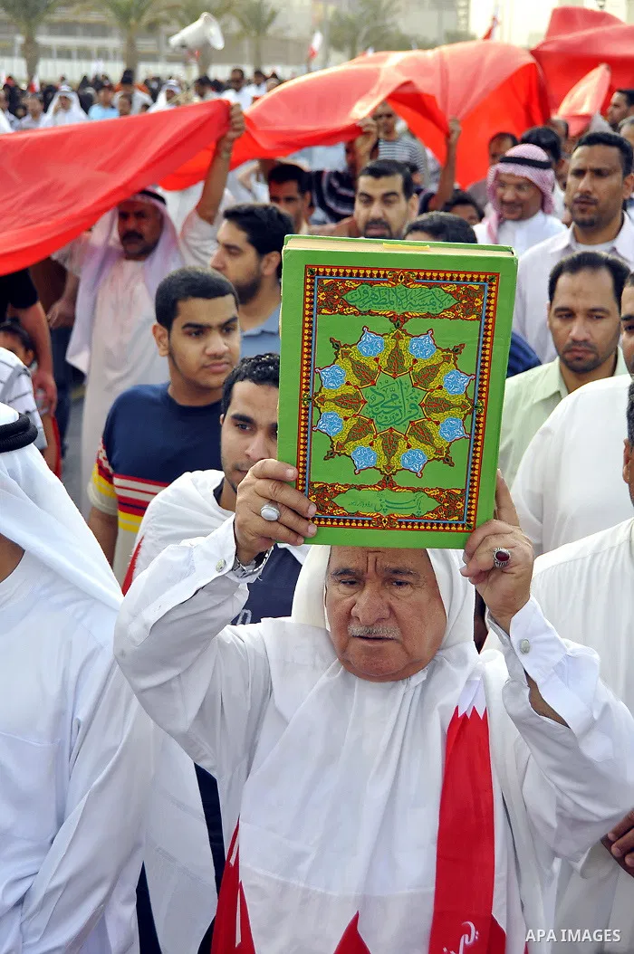 Thousands of Bahraini anti-government demonstrators chant slogans against the king on March 11, 2011 as they march toward the royal palace in Manama where a group of pro-regime loyalists waited with clubs, swords and met...