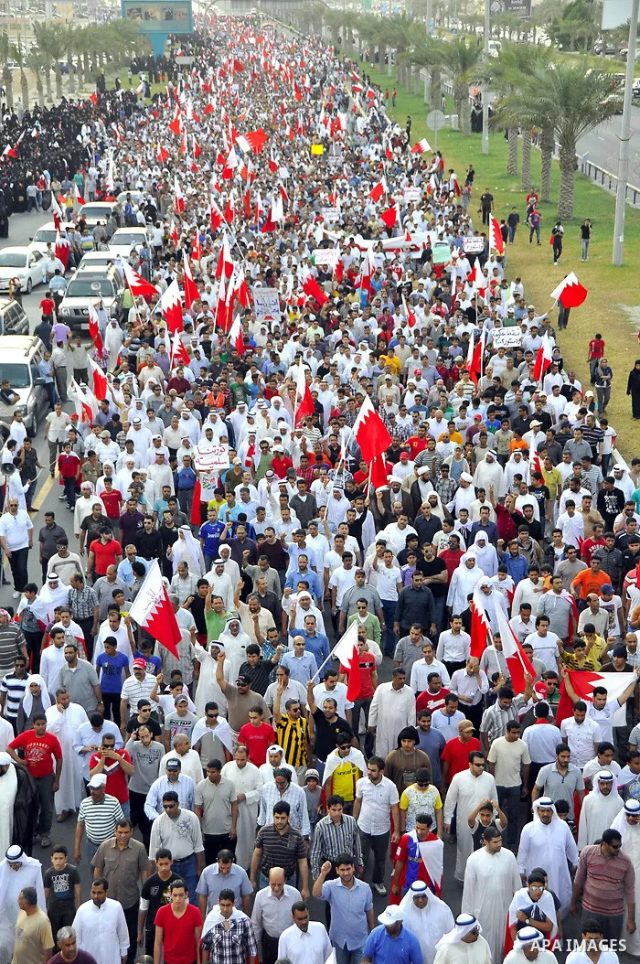 Thousands of Bahraini anti-government demonstrators chant slogans against the king on March 11, 2011 as they march toward the royal palace in Manama where a group of pro-regime loyalists waited with clubs, swords and met...