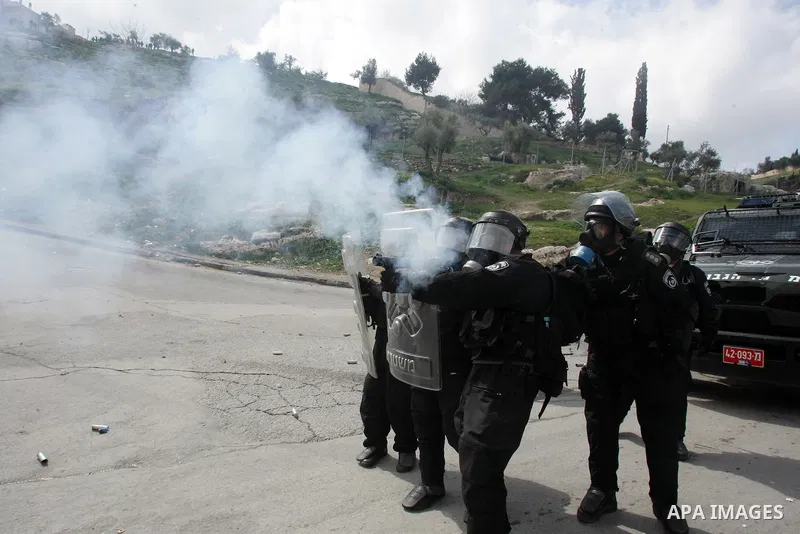 Israeli security officer shots a tear gas canister towards Palestinian stone-throwers, not pictured, during clashes in the east Jerusalem neighborhood of Silwan, Friday, March 11, 2011. Photo by Mahfouz Abu Turk