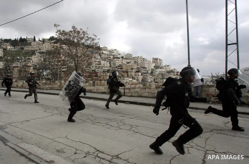 Israeli security officer shot a tear gas canister towards Palestinian stone-throwers, not pictured, during clashes in the east Jerusalem neighborhood of Silwan, Friday, March 11, 2011. Photo by Mahfouz Abu Turk