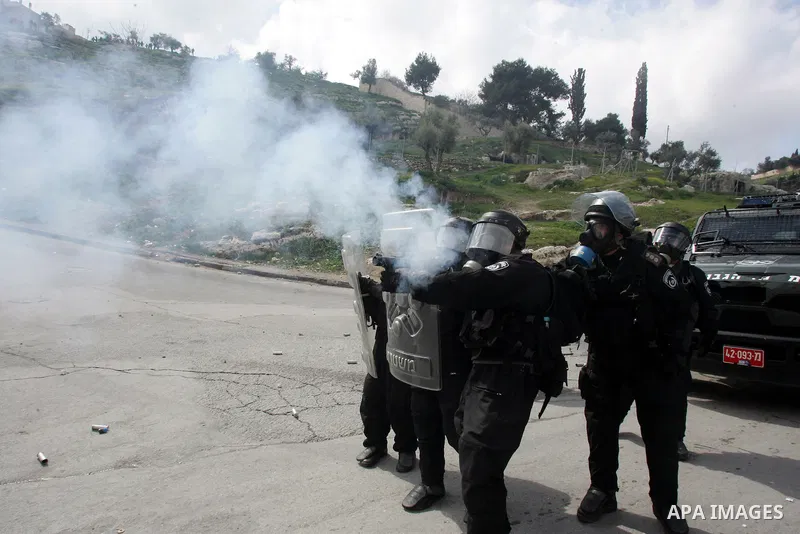 Israeli security officer shot a tear gas canister towards Palestinian stone-throwers, not pictured, during clashes in the east Jerusalem neighborhood of Silwan, Friday, March 11, 2011. Photo by Mahfouz Abu Turk