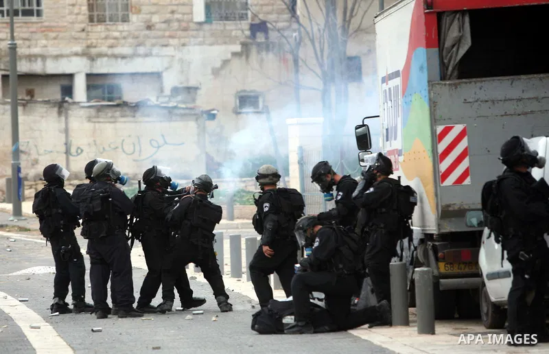 Israeli security officer shots a tear gas canister towards Palestinian stone-throwers, not pictured, during clashes in the east Jerusalem neighborhood of Silwan, Friday, March 11, 2011. Photo by Sliman Khader