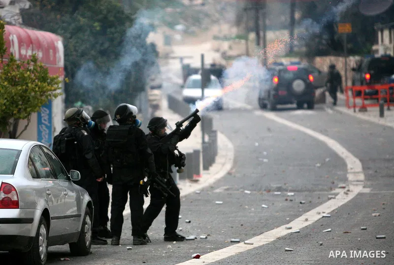 Israeli security officer shots a tear gas canister towards Palestinian stone-throwers, not pictured, during clashes in the east Jerusalem neighborhood of Silwan, Friday, March 11, 2011. Photo by Sliman Khader