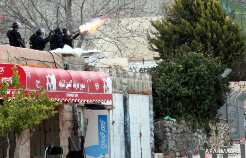 Israeli security officer shots a tear gas canister towards Palestinian stone-throwers, not pictured, during clashes in the east Jerusalem neighborhood of Silwan, Friday, March 11, 2011. Photo by Sliman Khader