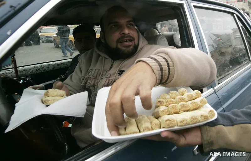 Palestinians distribute desserts celebrating the attack at the Jewish settlement of Itmar near Nablus in Rafah on March 12, 2011. A Palestinian infiltrated Itamar early Saturday and killed five people, the Israeli milita...