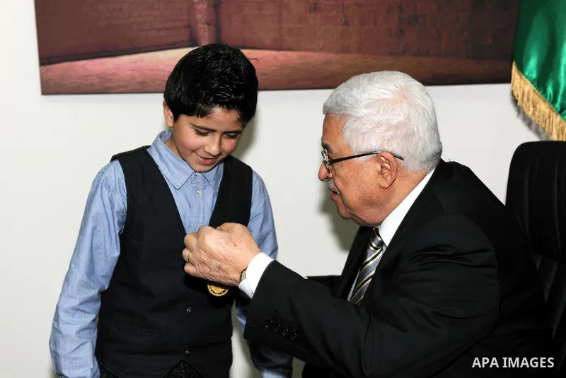 President Mahmoud Abbas (Abu Mazen) meets the child Issam Bashiti in Ramallah March 12, 2011. Photo by Thaer Ganaim
