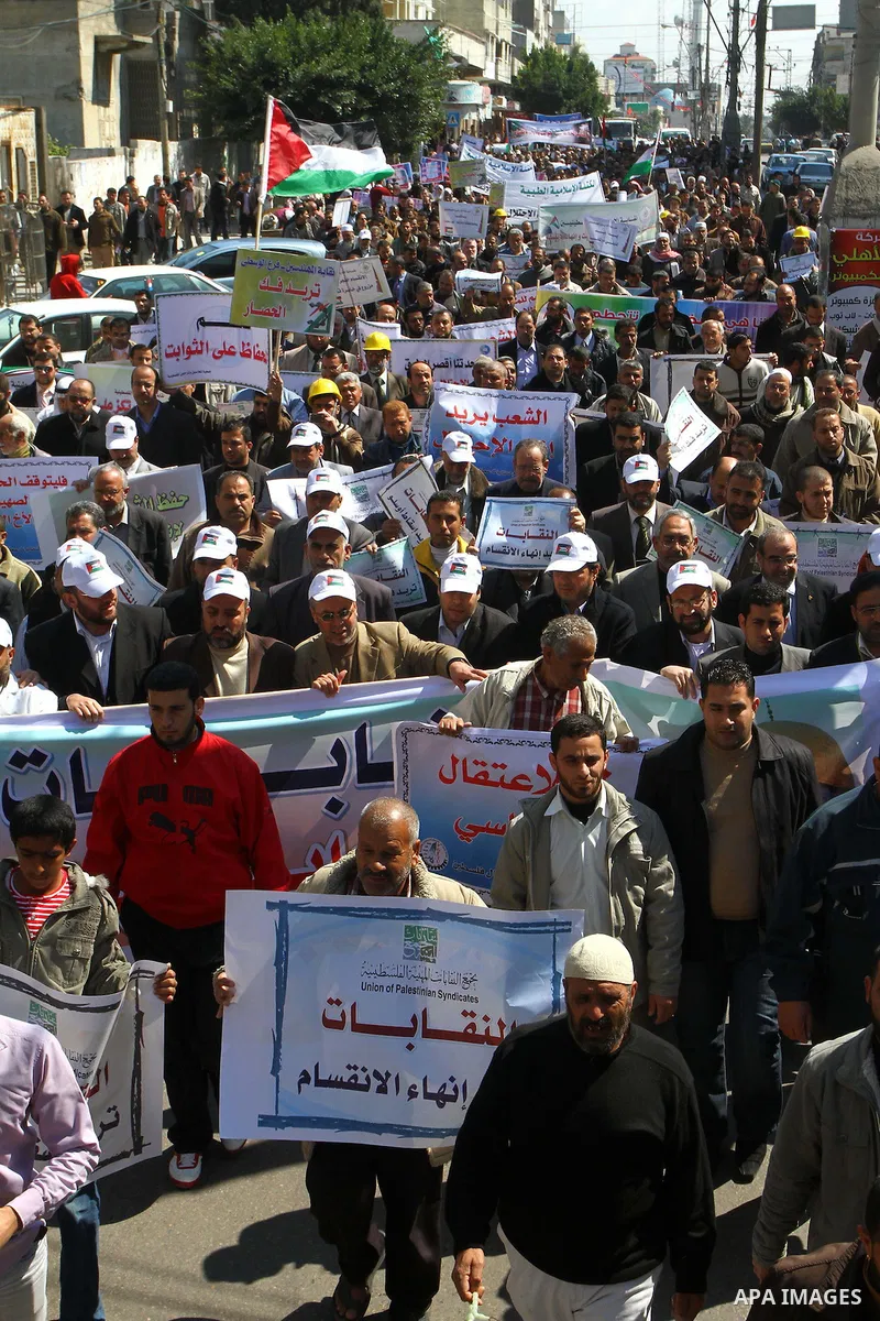 Palestinians hold signs during a protest calling for a national reconciliation between the tow parties Fatah and Hamas in Gaza City on March 12, 2011. Photo by Ashraf Amra
