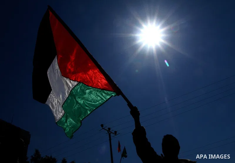 Palestinians hold signs during a protest calling for a national reconciliation between the tow parties Fatah and Hamas in Gaza City on March 12, 2011. Photo by Ashraf Amra