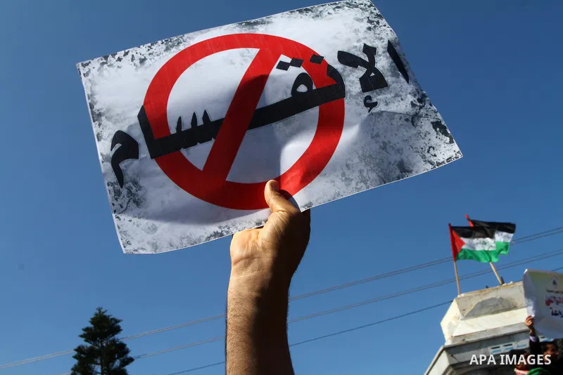 Palestinians hold signs during a protest calling for a national reconciliation between the tow parties Fatah and Hamas in Gaza City on March 12, 2011. Photo by Ashraf Amra