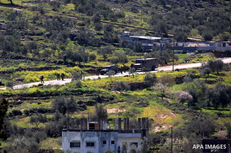 Israelis soldiers are seen in the street in the village of Awarta near the West Bank town of Nablus, March 12, 2011. A Palestinian infiltrated a Jewish West Bank settlement early killed five people, the Israeli military...