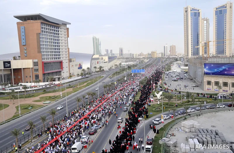 Thousands of Bahraini anti-government demonstrators chant slogans against the king on March 11, 2011 as they march toward the royal palace in Manama where a group of pro-regime loyalists waited with clubs, swords and met...