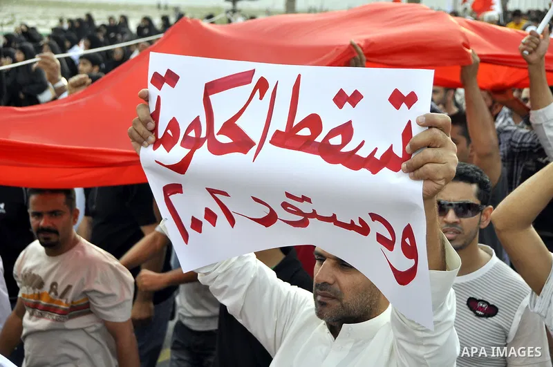 Thousands of Bahraini anti-government demonstrators chant slogans against the king on March 11, 2011 as they march toward the royal palace in Manama where a group of pro-regime loyalists waited with clubs, swords and met...
