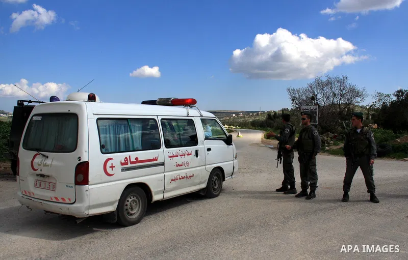 An Israeli soldier stops Palestinians for a security check in the West Bank village of Awarta south of Nablus on 13 March 2011. Israeli troops raided the village, arresting people and searching houses a day after a Pales...