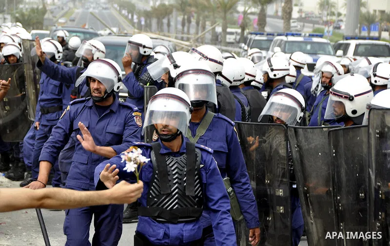 Bahraini anti-government protesters demonstrate in front of riot police on an overpass near Pearl roundabout Sunday, March 13, 2011, in Manama, Bahrain. Photo by Ammar A.rasool