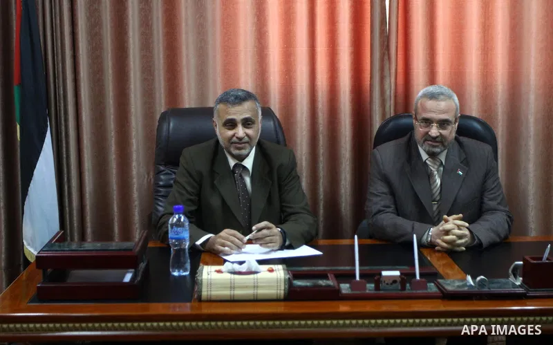 Palestinian minister, Mohammed Asqoul receives the General Secretariat of the Council of Ministers from the minister, Mohammed Awad in Gaza City on March 13,2011. Photo by Ashraf Amra