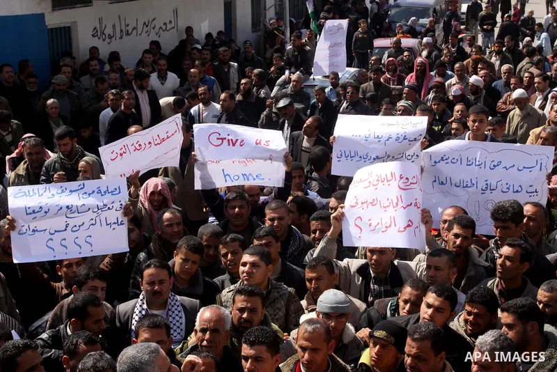 Palestinian lost their homes during the Israeli war in 2008-2009 attend a gathering calling for ending the siege in front of the United Nations Relief and Works Agency (UNRWA) headquarters in Gaza City March 13,2011. Pho...