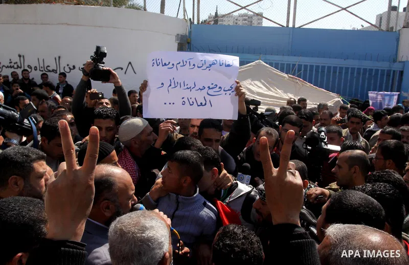 Palestinian lost their homes during the Israeli war in 2008-2009 attend a gathering calling for ending the siege in front of the United Nations Relief and Works Agency (UNRWA) headquarters in Gaza City March 13,2011. Pho...