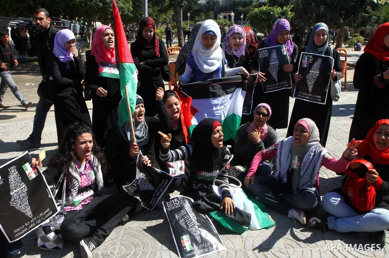 Palestinians participate in a march calling for a reconciliation between the rival Palestinian leading factions Hamas in Gaza and Fatah in the West Bank, in Gaza City, Monday, March 14, 2011. Photo by Ashraf Amra