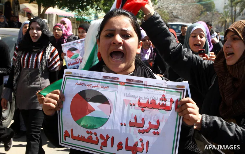 Palestinians participate in a march calling for a reconciliation between the rival Palestinian leading factions Hamas in Gaza and Fatah in the West Bank, in Gaza City, Monday, March 14, 2011. Photo by Ashraf Amra