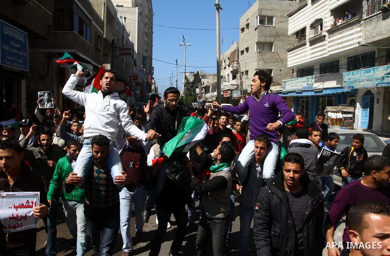 Palestinians participate in a march calling for a reconciliation between the rival Palestinian leading factions Hamas in Gaza and Fatah in the West Bank, in Gaza City, Monday, March 14, 2011. Photo by Ashraf Amra