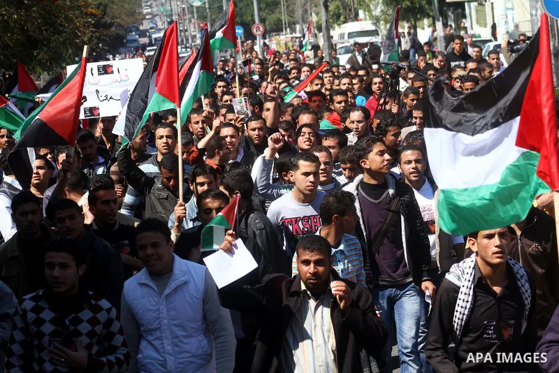 Palestinians participate in a march calling for a reconciliation between the rival Palestinian leading factions Hamas in Gaza and Fatah in the West Bank, in Gaza City, Monday, March 14, 2011. Photo by Ashraf Amra