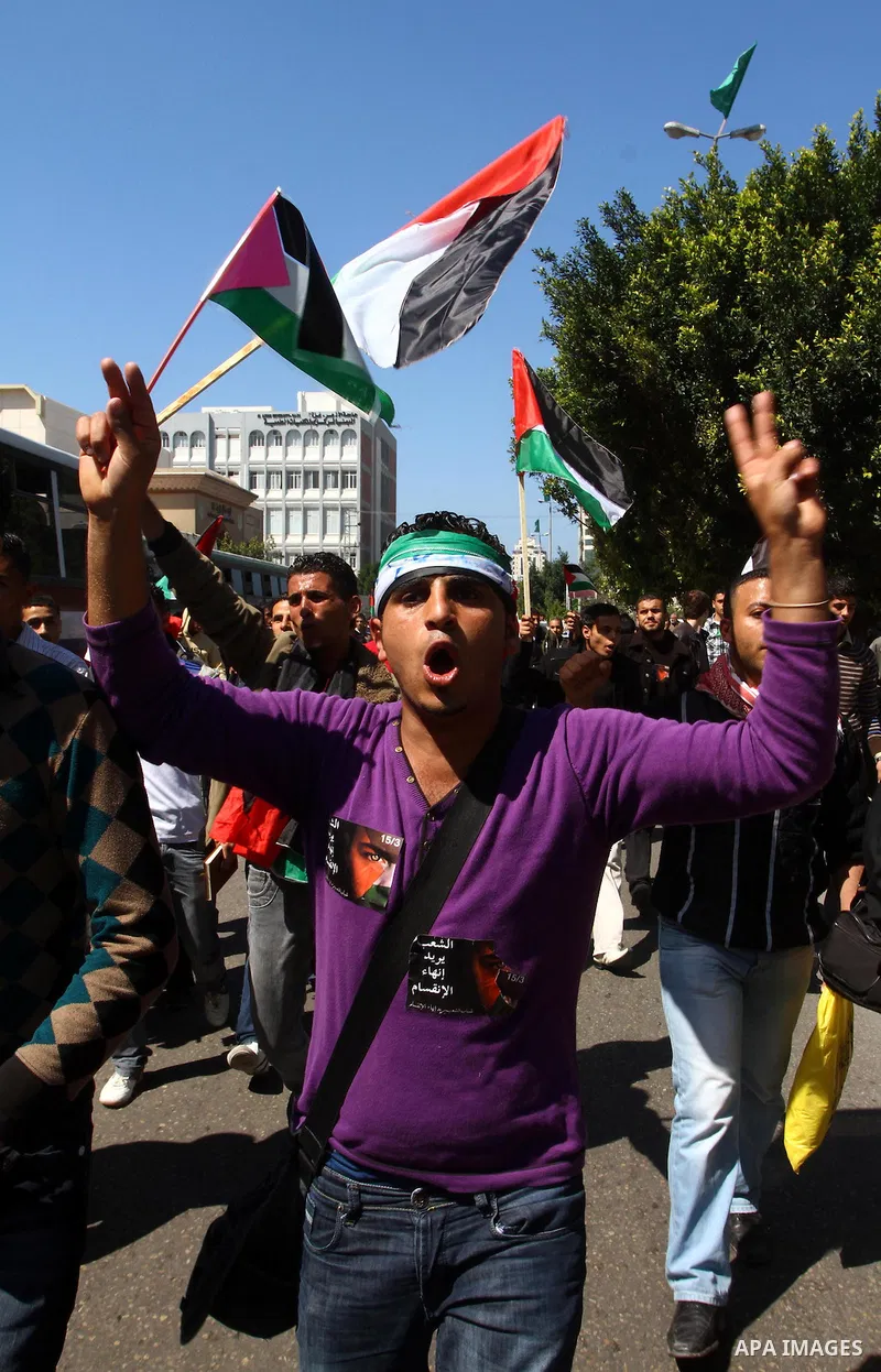 Palestinians participate in a march calling for a reconciliation between the rival Palestinian leading factions Hamas in Gaza and Fatah in the West Bank, in Gaza City, Monday, March 14, 2011. Photo by Ashraf Amra