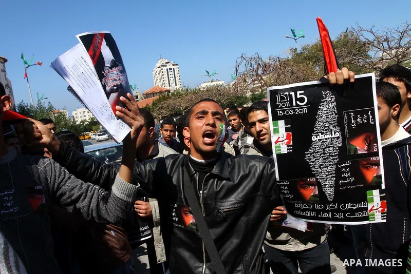 Palestinians participate in a march calling for a reconciliation between the rival Palestinian leading factions Hamas in Gaza and Fatah in the West Bank, in Gaza City, Monday, March 14, 2011. Photo by Ashraf Amra
