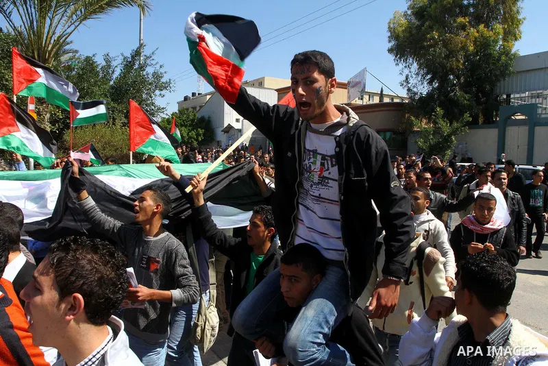 Palestinians participate in a march calling for a reconciliation between the rival Palestinian leading factions Hamas in Gaza and Fatah in the West Bank, in Gaza City, Monday, March 14, 2011. Photo by Ashraf Amra
